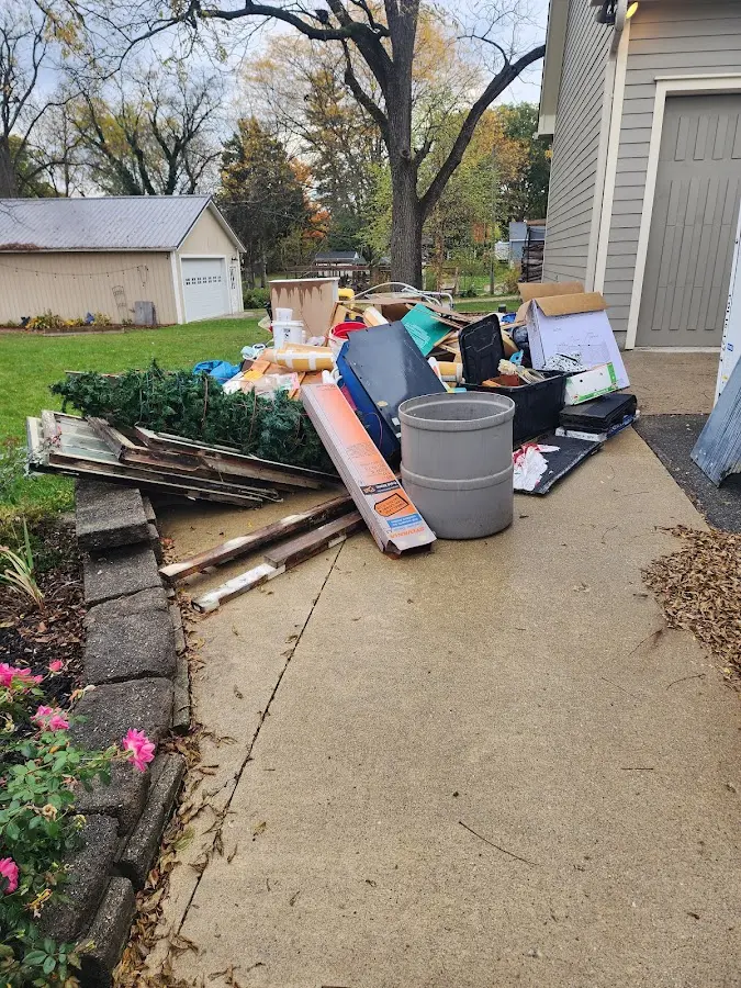 Dumpster being loaded with debris for Estate Cleanout Dumpster Rental in Columbia